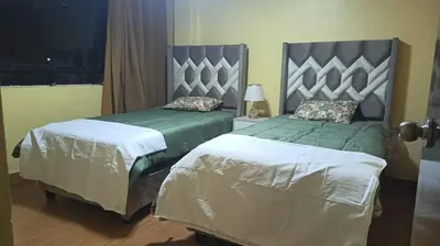 two beds in a hotel room with at Boulevard home hostel - Lima Airport in Lima