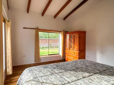 a bedroom with a bed and a window at Cancha Wasi A modern, cozy and fully equipped house in Urubamba