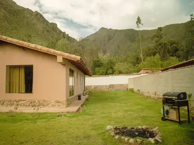 a backyard of a house with a grill in the yard at Mountain retreat with private sauna in Urubamba in Urubamba