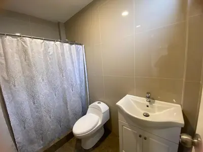a bathroom with a toilet and a sink at La Casona - Hospedaje Campestre in El Carmen