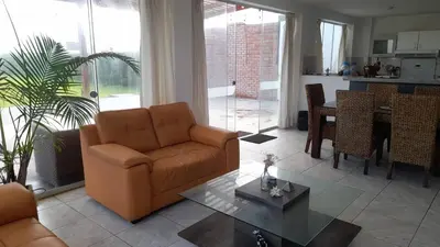 a living room with a couch and a table at Casa Frente al mar en club privado in Lurín