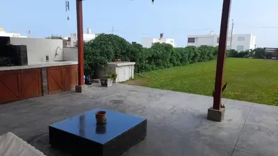a patio with a table and a view of a yard at Casa Frente al mar en club privado in Lurín