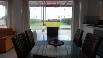 a dining room table with chairs and a tableasteryasteryasteryasteryasteryasteryastery at Casa Frente al mar en club privado in Lurín