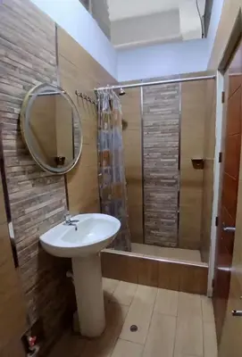 a bathroom with a sink and a shower with a mirror at Princess Hotel in Supe