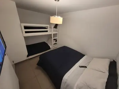 a small room with a bed and a tv at Casa de playa Cala del Mar Experience in Bujama Baja