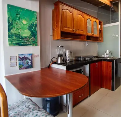 a kitchen with a wooden table in a room at Mini Apartment Flat in the heart of Cusco - Close to Main Square in Cusco