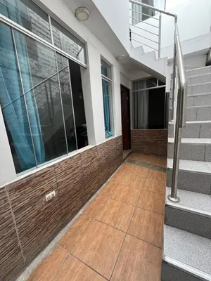 a house with a wooden floor and a staircase at Departamento Playa El Silencio in Punta Hermosa