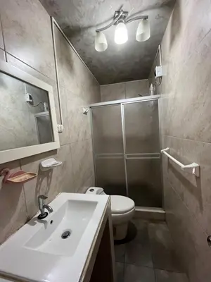 a bathroom with a shower and a sink and a toilet at Departamento Playa El Silencio in Punta Hermosa