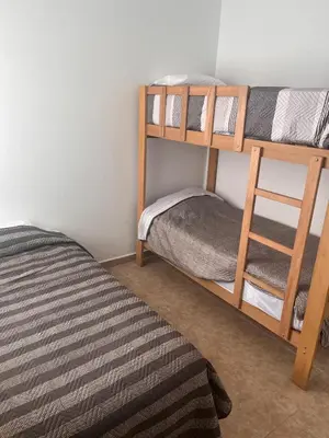a bedroom with two bunk beds and a bed at Departamento 101 in Punta Negra