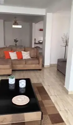 a living room with a couch and a table at Casa pulpos in Punta Hermosa