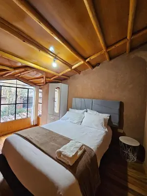 a bedroom with a large bed in a room at Condomino Villa Andina in Urubamba
