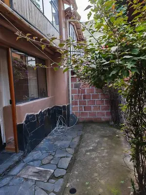 a brick building with a door and a window at Condomino Villa Andina in Urubamba