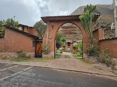 an entry to a house with an arch on a street at Condomino Villa Andina in Urubamba