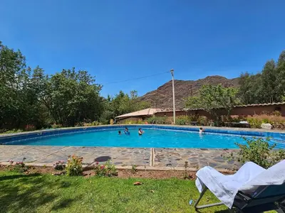 a large swimming pool with people in it at Condomino Villa Andina in Urubamba