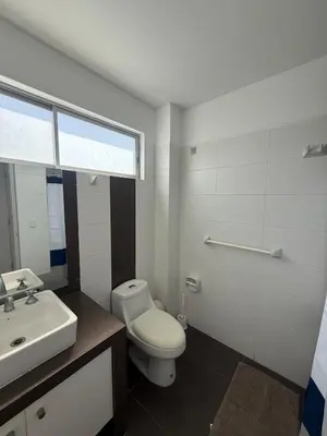 a bathroom with a white toilet and a sink at Oceanfront apartment con opcion de Velero in Paracas
