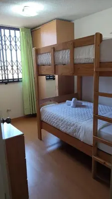 a bedroom with two bunk beds and a window at EL rincon feliz in San Antonio