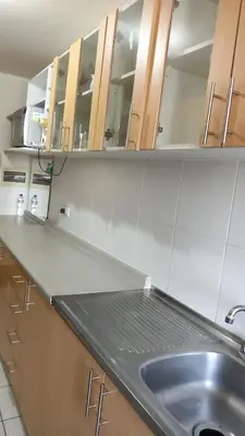 a kitchen with a sink and wooden cabinets at EL rincon feliz in San Antonio