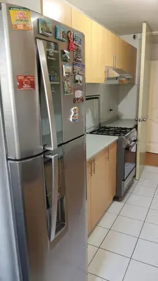 a kitchen with a stainless steel refrigerator with magnets at EL rincon feliz in San Antonio