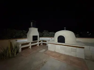 a building with an outdoor oven at night at Casa de campo Rosenthal - Cieneguilla in Panquilma