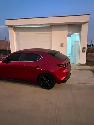 a red car parked in front of a garage at CASA CERCA a PLAYA NAPLO CON PISCINA in Pucusana