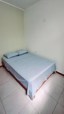 a bedroom with a large bed in a room at Departamento independiente anexo a vivienda familiar in La Tinguiña