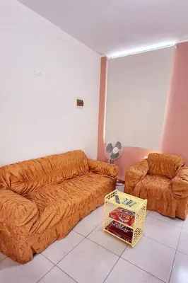 a living room with a couch and a chair at Departamento independiente anexo a vivienda familiar in La Tinguiña