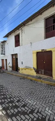 a white building with two garage doors on a street at Hotel Los Andenes in Cotahuasi