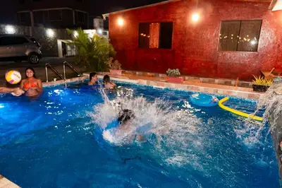 a group of people playing in a swimming pool at Las Delicias in Huacho