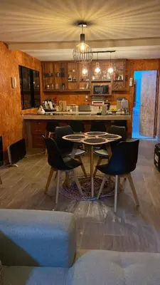 a kitchen with a table and chairs in a room at Las Delicias in Huacho