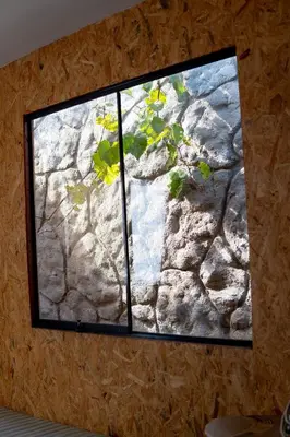 a window on a wall with a stone wall at Las Delicias in Huacho