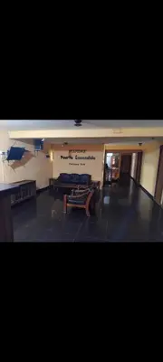 a room with tables and benches in a building at Hospedaje Puerto Escondido in Pucusana