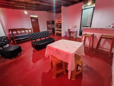 a room with a table and some chairs and a table andools at Casita de camucha segundo piso in Chincha Baja