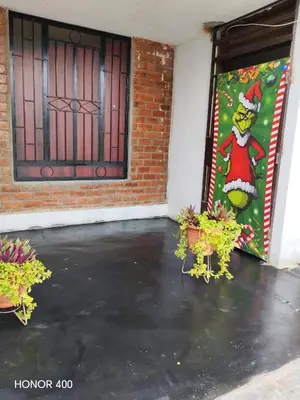 a room with a door with a christmas banner at Casita de camucha segundo piso in Chincha Baja
