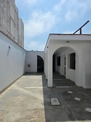 an alleyway between two white buildings with an archway at Casa san Bartolo in San Bartolo
