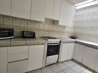 a white kitchen with a stove and a microwave at Casa san Bartolo in San Bartolo