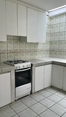 a kitchen with a stove and white cabinets at Casa san Bartolo in San Bartolo