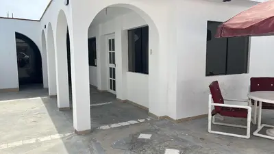 a room with a table and chairs and a white wall at Casa san Bartolo in San Bartolo