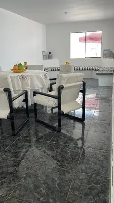 a dining room with a table and chairs and a table at Casa san Bartolo in San Bartolo