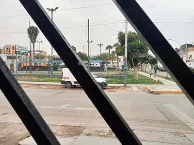 a view of a street through a metal fence at Departamento habitación cama king in Lima