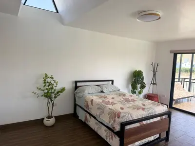 a bedroom with a bed in a white room at Casa Hacienda El Triangulo - Asia del Campo in Asia
