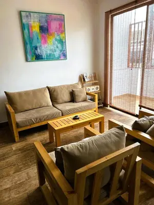 a living room with a couch and a table at Beach house in Punta Hermosa, central beach area in Punta Hermosa
