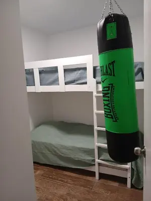 a bedroom with a bunk bed and a large inflatable water bottle at Beach house in Punta Hermosa, central beach area in Punta Hermosa