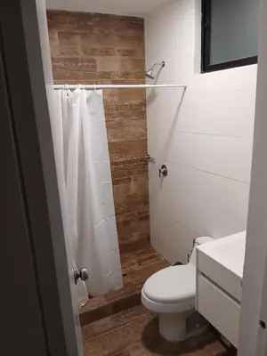a bathroom with a toilet and a shower at Beach house in Punta Hermosa, central beach area in Punta Hermosa