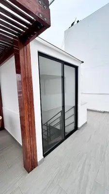 an open glass door on a white building at Beach house in Punta Hermosa, central beach area in Punta Hermosa