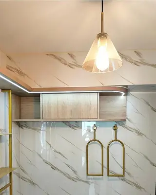 a kitchen with two lights and marble counter tops at Apartamento amoblado in Lima