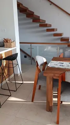 a room with a table and chairs and a staircase at Casa de Playa a 15min del boulevard de Asia in Cerro Azul