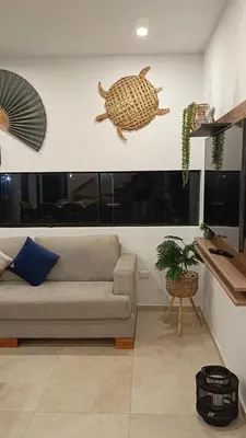 a living room with a couch and a turtle on the wall at Casa de Playa a 15min del boulevard de Asia in Cerro Azul