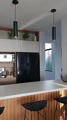 a kitchen with a black refrigerator and black stools at Casa de Playa a 15min del boulevard de Asia in Cerro Azul