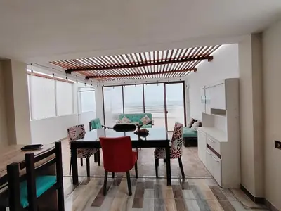 a dining room with a table and some chairs at Hospedaje Ocean Glips in Punta Negra