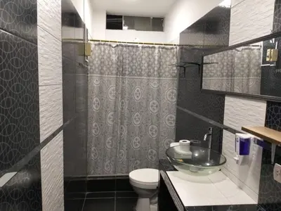 a bathroom with a sink and a toilet and a shower at Hospedaje Ocean Glips in Punta Negra